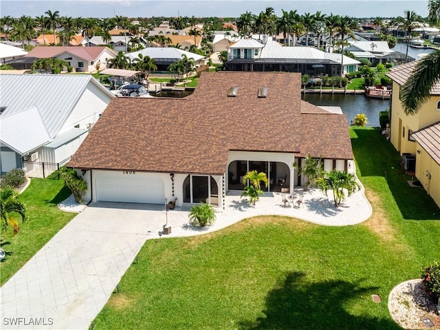 birds eye view of property with a water view