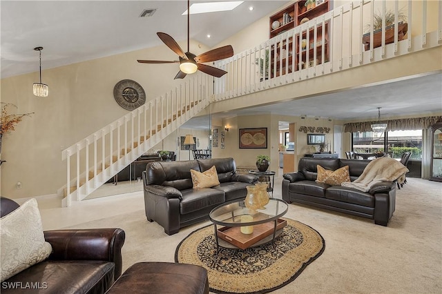 carpeted living room with high vaulted ceiling and ceiling fan