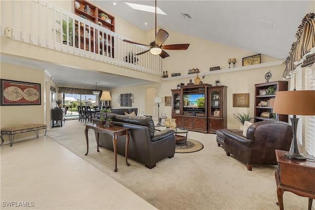 living room featuring a towering ceiling, light tile patterned flooring, and ceiling fan