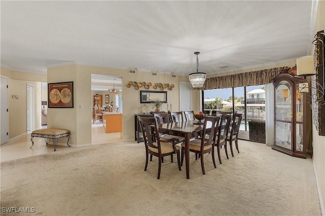 carpeted dining area featuring crown molding and a notable chandelier