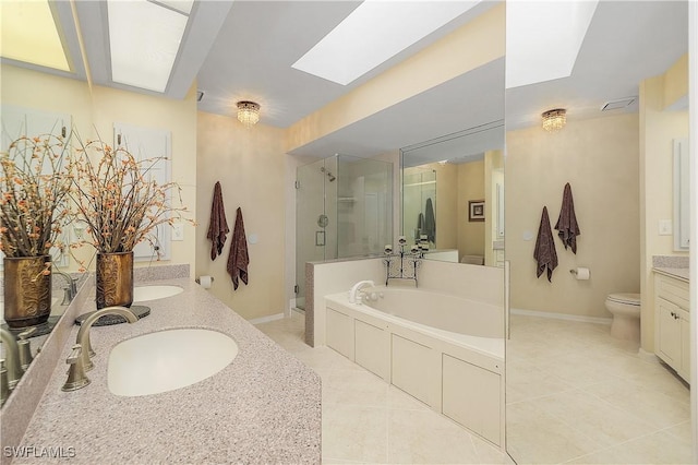 full bathroom with shower with separate bathtub, tile patterned flooring, toilet, a skylight, and vanity