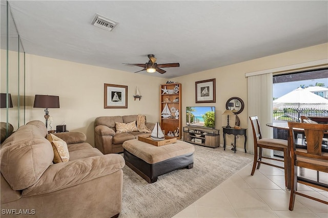 living room with ceiling fan and light tile patterned floors