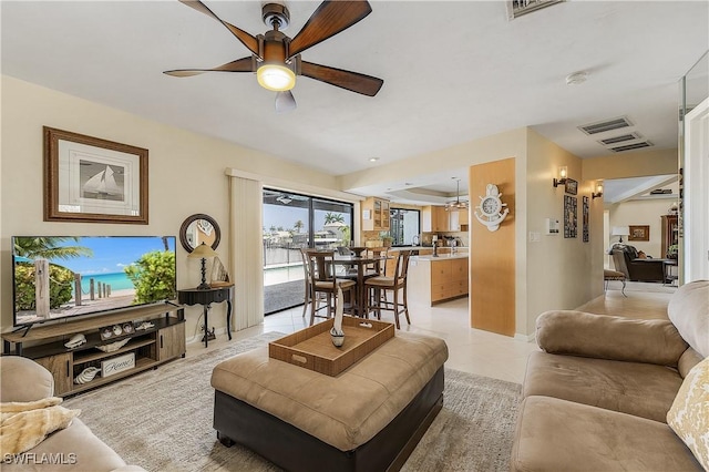 tiled living room featuring ceiling fan