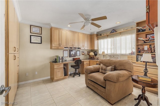 office area featuring ceiling fan, built in desk, and crown molding