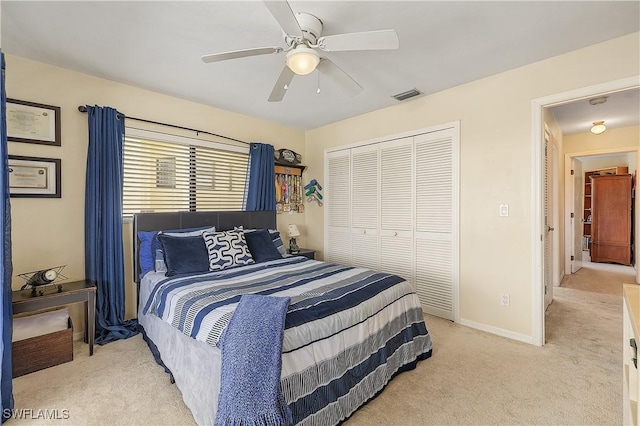 carpeted bedroom with ceiling fan and a closet