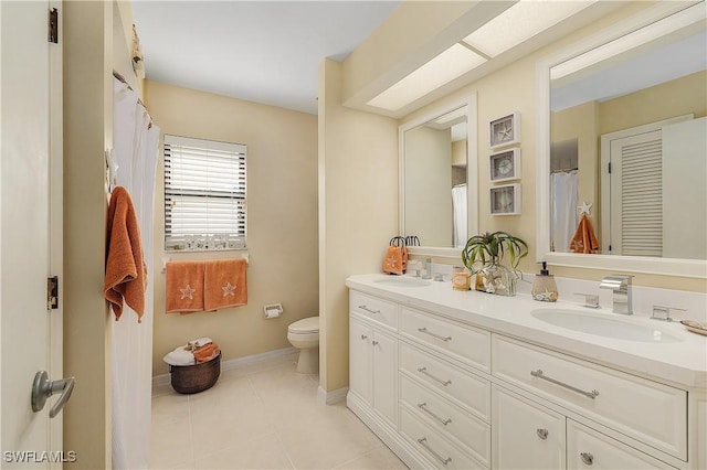 bathroom featuring toilet, tile patterned floors, and vanity