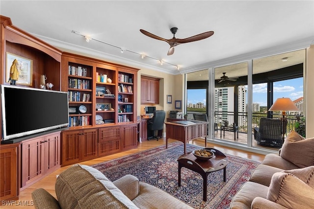 living room featuring expansive windows, light wood-type flooring, and ornamental molding