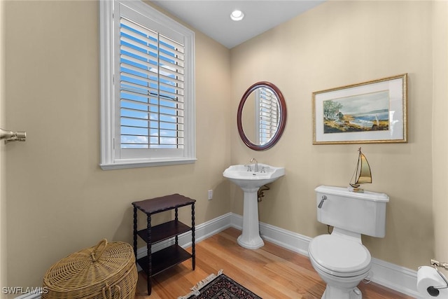 bathroom featuring hardwood / wood-style flooring and toilet