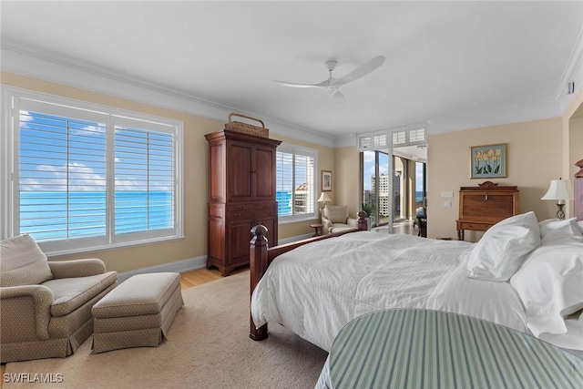 bedroom with ceiling fan, crown molding, and light hardwood / wood-style flooring