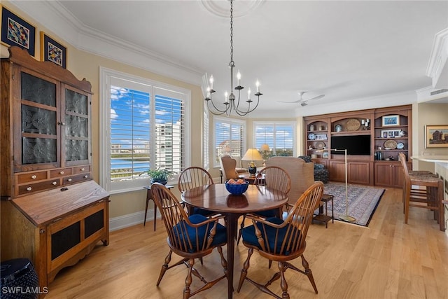 dining area with light hardwood / wood-style floors, ceiling fan with notable chandelier, and ornamental molding