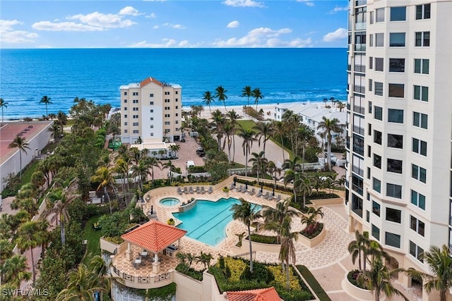 drone / aerial view of a pool area and a nearby body of water