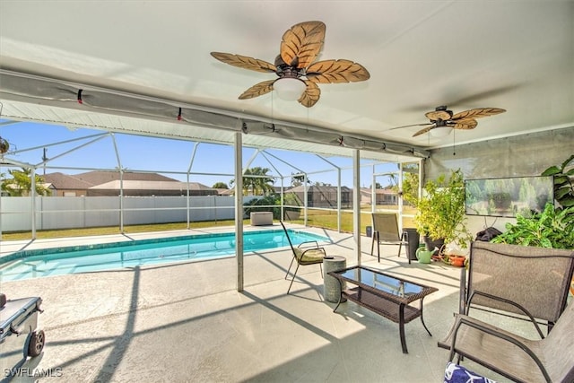 view of pool with ceiling fan, a lanai, and a patio area