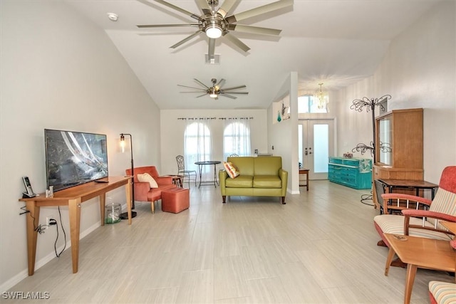 living area with lofted ceiling, french doors, and ceiling fan with notable chandelier