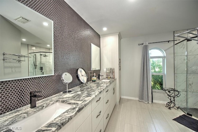 bathroom with walk in shower, decorative backsplash, and vanity