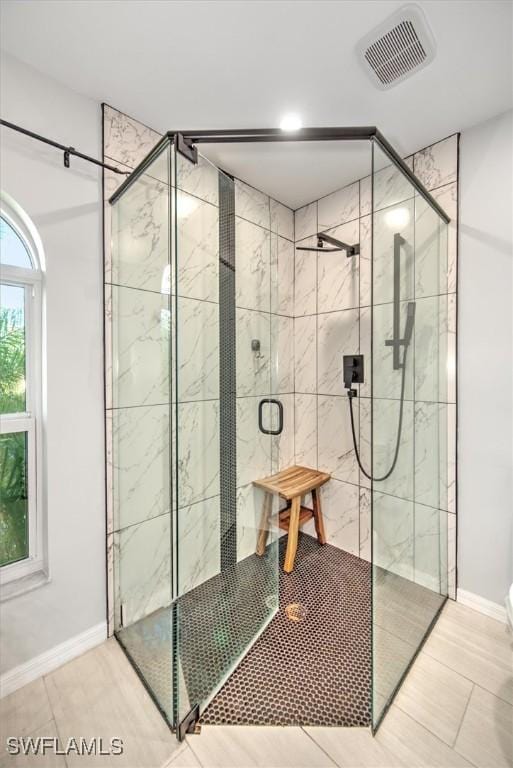 bathroom featuring walk in shower and tile patterned floors