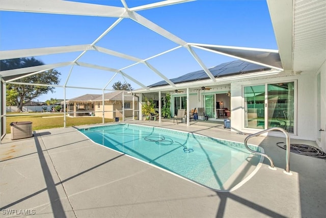 view of swimming pool with a lanai, ceiling fan, and a patio