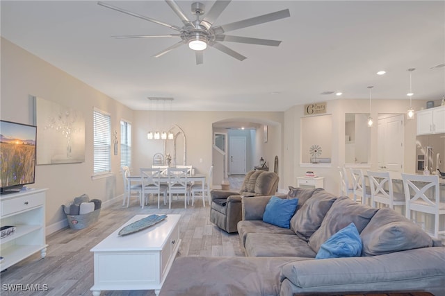 living room with ceiling fan and light hardwood / wood-style floors