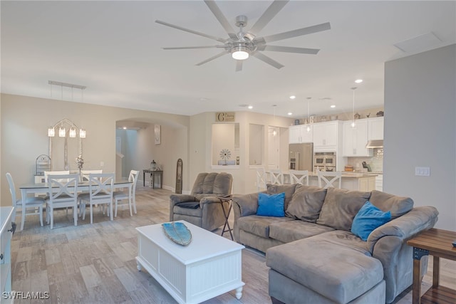 living room with ceiling fan and light wood-type flooring