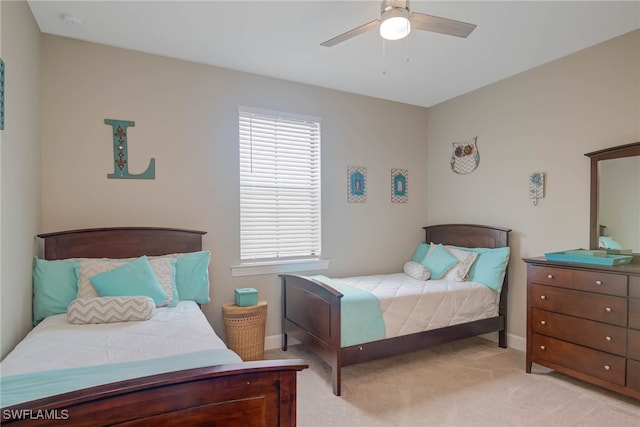 carpeted bedroom featuring ceiling fan and multiple windows