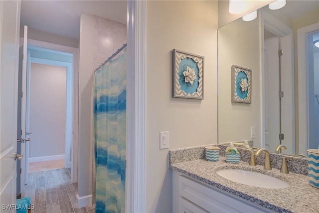 bathroom with a shower with curtain and vanity