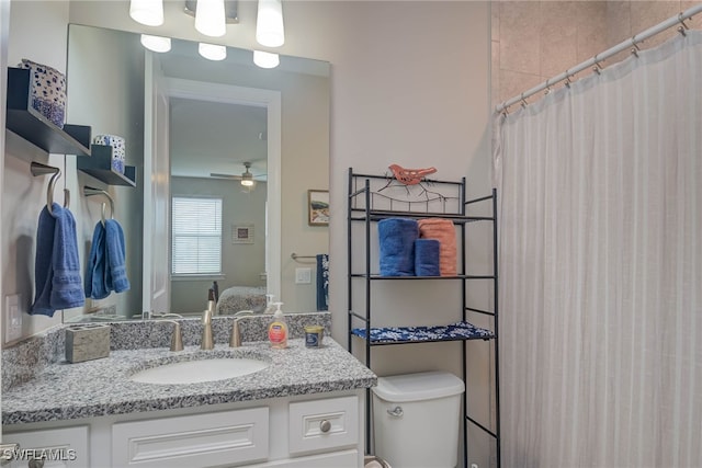 bathroom with toilet, ceiling fan, a shower with curtain, and vanity