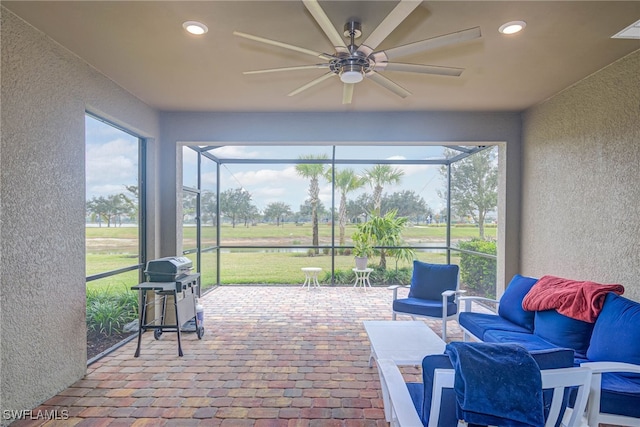 sunroom featuring ceiling fan