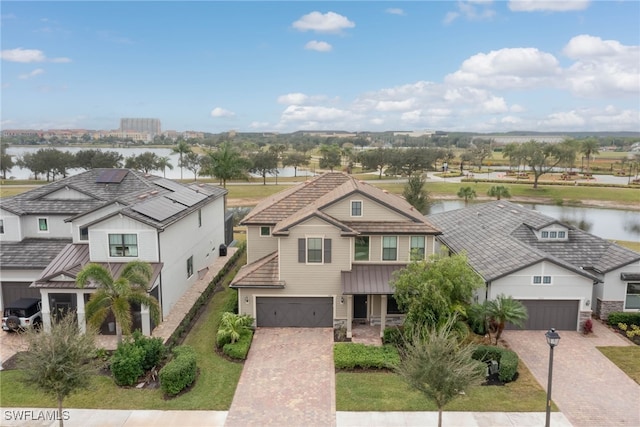 view of front of property featuring a garage and a water view