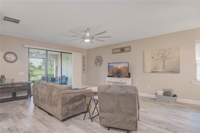 living room with ceiling fan and light hardwood / wood-style flooring