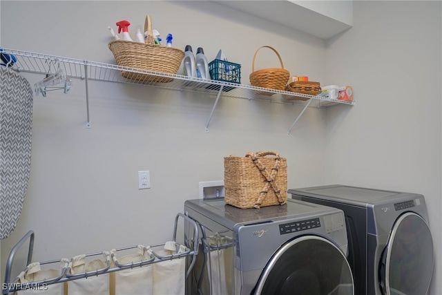 clothes washing area featuring washing machine and clothes dryer