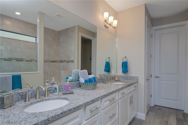 bathroom featuring hardwood / wood-style flooring and vanity