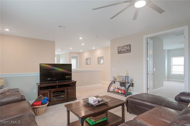 living room featuring light carpet and ceiling fan