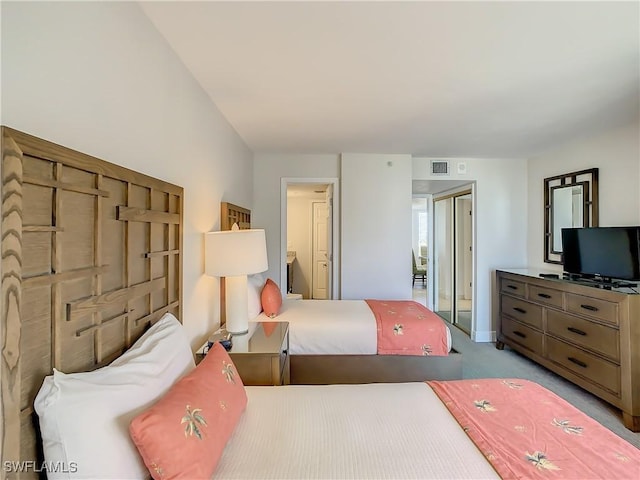 carpeted bedroom with a closet