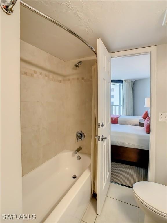 bathroom featuring toilet, tile patterned flooring, and shower / bath combo