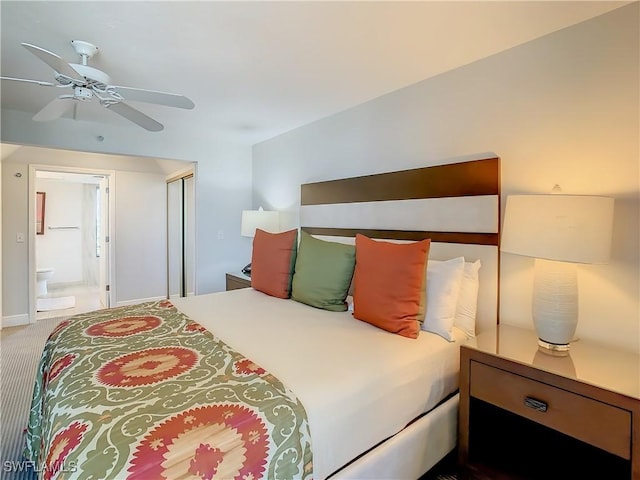 carpeted bedroom with ceiling fan and ensuite bath