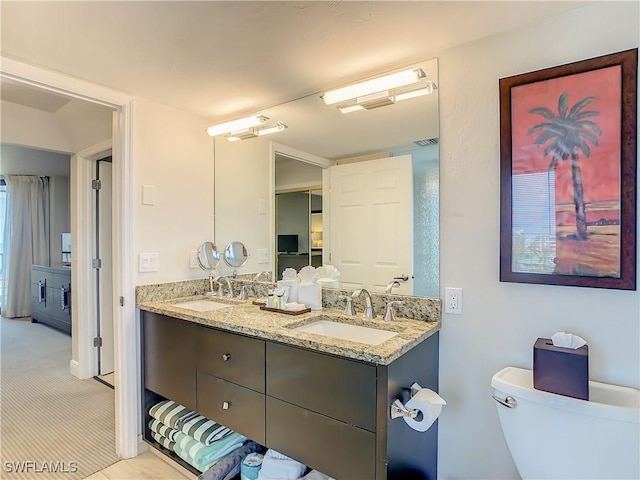 bathroom featuring vanity and toilet