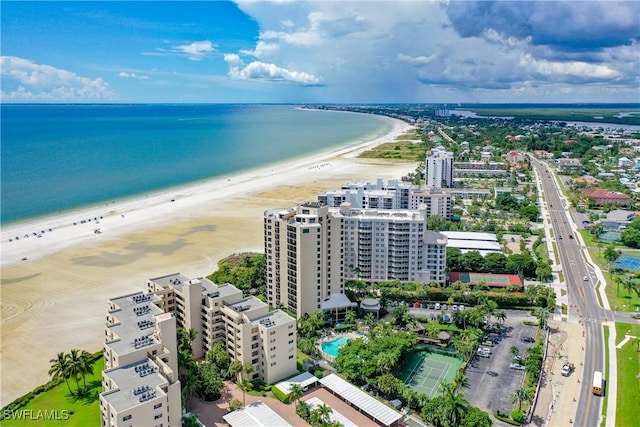 birds eye view of property with a water view and a beach view