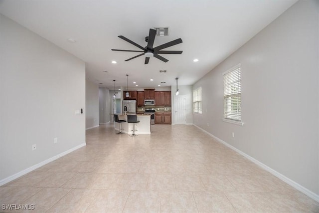 tiled living room featuring ceiling fan