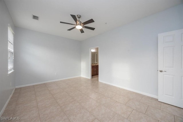 tiled empty room with ceiling fan