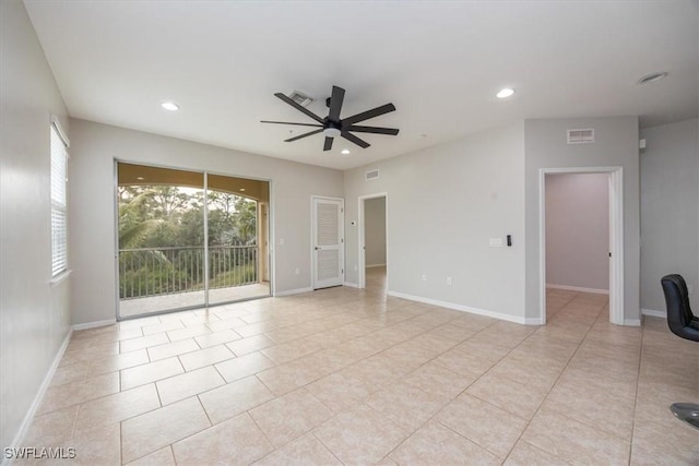 tiled spare room featuring ceiling fan