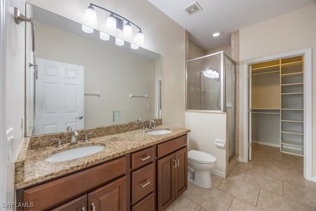 bathroom with toilet, tile patterned flooring, an enclosed shower, and vanity