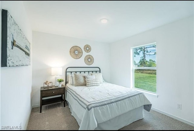 carpeted bedroom featuring baseboards