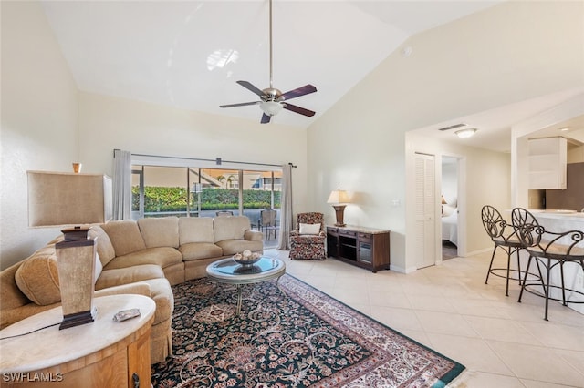 living room featuring ceiling fan, light tile patterned floors, and high vaulted ceiling