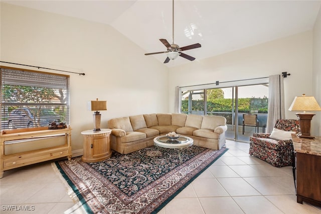 tiled living room with ceiling fan and high vaulted ceiling