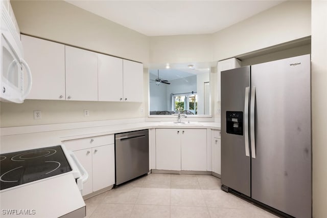 kitchen with ceiling fan, sink, light tile patterned flooring, white cabinetry, and appliances with stainless steel finishes