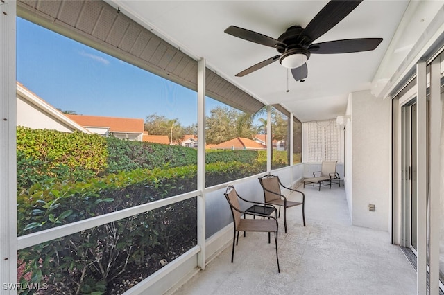 sunroom featuring ceiling fan