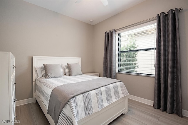 bedroom featuring light wood-type flooring and ceiling fan