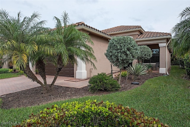 view of side of home featuring a yard and a garage