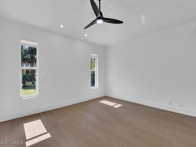 spare room with wood-type flooring and ceiling fan