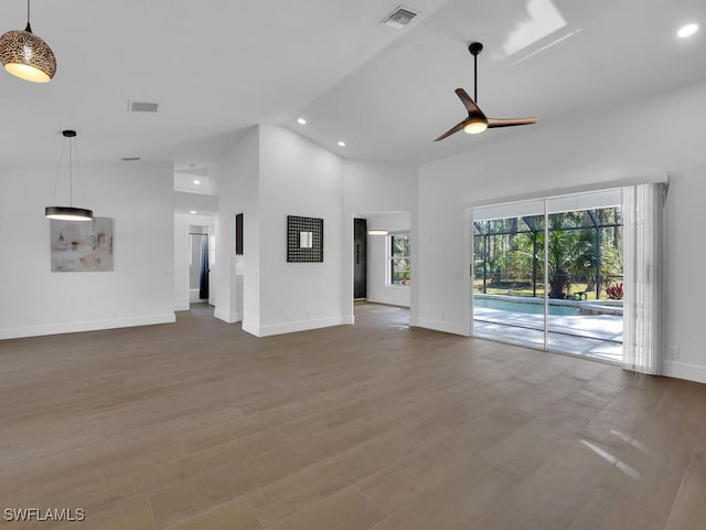 unfurnished living room featuring high vaulted ceiling, hardwood / wood-style floors, and ceiling fan