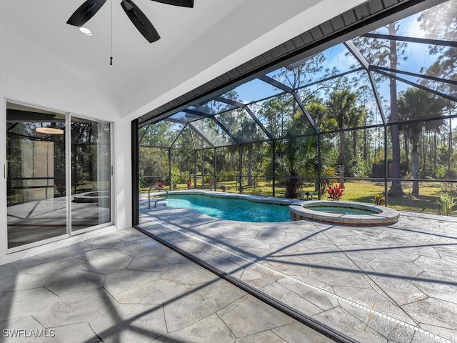 view of pool with an in ground hot tub, a patio, and glass enclosure